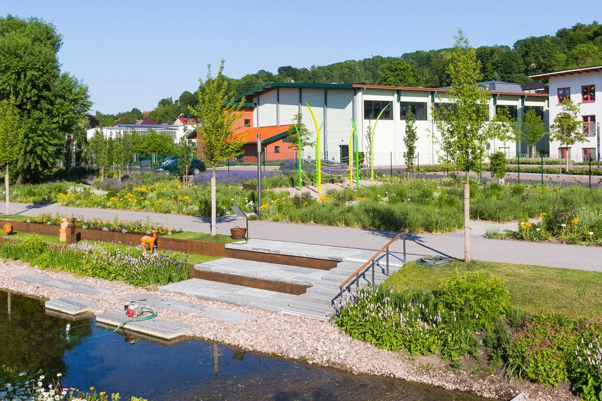 Bildbeschreibung / description: Ein Fluss, der durch einen Park fließt, umgeben von Bäumen und Grünflächen, ideal für Erholung und Naturgenuss.